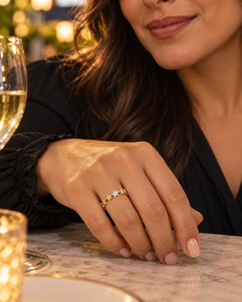 Tri-color gold star ring worn naturally in an evening look