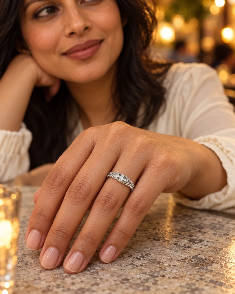 Curved vintage white gold diamond ring worn naturally in an evening look